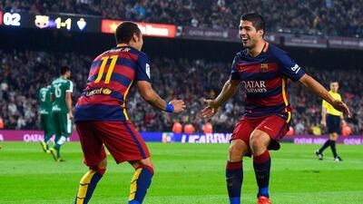 Luis Suarez celebrates his second goal with Neymar in their La Liga match against Eibar on Sunday at the Camp Nou. David Ramos / Getty Images