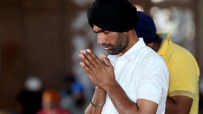 Devotees pray at the Sikh Gurudwara, Guru Nanak Darbar in Dubai. Satish Kumar / The National