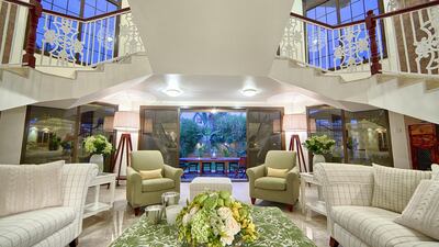 Symmetry was also maintained in staircase and seating arrangement. The decor was kept calm and ordered, without too much clutter, but with bright injections of colours to bring the garden inside, as it were. Plant life and shades of green lend vibrancy