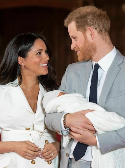 Britain's Prince Harry and Meghan, Duchess of Sussex smile during a photocall with their newborn son, Archie Harrison, in St George's Hall at Windsor Castle, Windsor, south England. AP
