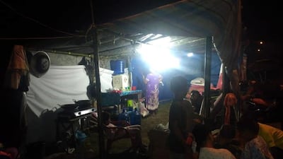 Displaced people gathering at a makeshift shelter in Anyer. EPA