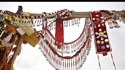 Camel bling, both traditional and modern worn by camels and sold buy merchants at the Al Dhafra Festival outside Abu Dhabi.