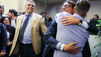 Staff members and supporters of Ms Meloni celebrate. Bloomberg