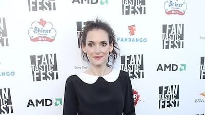 Winona Ryder walks the red carpet in a black dress with ruffled skirt and white collar at the premiere of Tim Burton's Frankenweenie at the Alamo Drafthouse in Austin, Texas, on September 20, 2012. FilmMagic