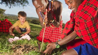 Jake Stuart learns how to light fires without matches with at Cottar’s Camp. Photo by Stuart Butler