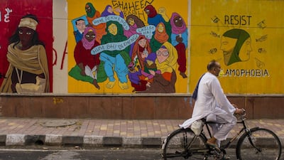 A man with a protective mask rides a moped on a deserted road, amid a nationwide lockdown to slow the spread of coronavirus, in New Delhi, India. Getty Images