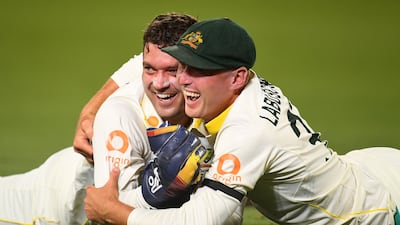 Australia wicketkeeper Alex Carey celebrates with teammate Marnus Labuschagne after taking a catch. Reuters
