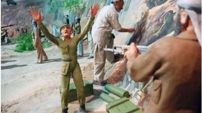 Nasrallah Sarway, the head artist at the Manzar-e-Jahad Museum does touch up work on the diorama he helped create.