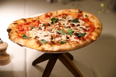 Pizza with tomatoes and oregano served at Paradiso at Yas Bay Waterfront. Khushnum Bhandari / The National