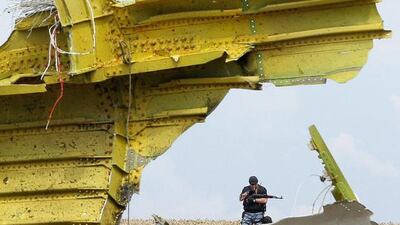 An armed rebel soldier guards the main crash site of the Boeing 777 Malaysia Airlines flight MH17. EPA/ROBERT GHEMENT