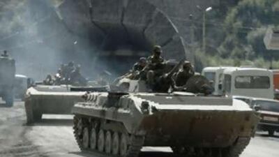 Russian armored vehicles drive out of a tunnel in Russia's North Ossetia today while leaving Georgia's separatist-controlled territory of South Ossetia. Russia's parliament voted unanimously today to urge the president to recognize the independence of Georgia's two breakaway regions, stoking further tension between Moscow and the small Caucasus nation's Western allies.