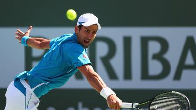 Novak Djokovic of Serbia in action against Milos Raonic of Canada during Day 14 of the BNP Paribas Open at Indian Wells Tennis Garden on March 20, 2016 in Indian Wells, California. Julian Finney/Getty Images/AFP