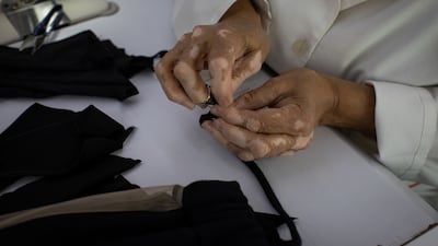 Laure Bassil manually sews a piece of fabric. Diamony Group produces up to 3,000 garments a month.