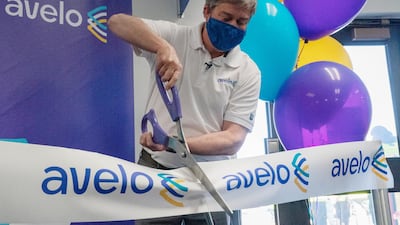 Andrew Levy, chief executive officer of Avelo Airlines, cuts a ceremonial ribbon ahead of the airline's inaugural flight. New money is flowing to low-cost airlines in the US as they take on giant carriers racing to recover from the unprecedented collapse in travel during the pandemic. Bloomberg