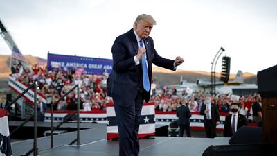 US President Donald Trump dances to the music as he departs at the end of a campaign rally in Carson City. Reuters