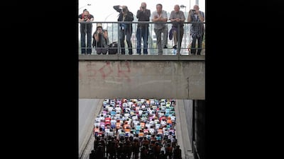 Spectators watch the passing pack from atop a bridge during the start of the first stage of the Tour de France cycling race over 198 kilometers (123 miles) with start in Liege and finish in Seraing, Belgium, Sunday July 1, 2012. (AP Photo/Christophe Ena)
