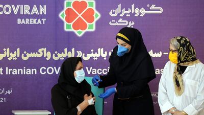 An Iranian health worker injects a dose of locally made CovIran Barekat Covid-19 vaccine in Tehran, Iran. CovIran Barekat received emergency approval in June. EPA-EFE