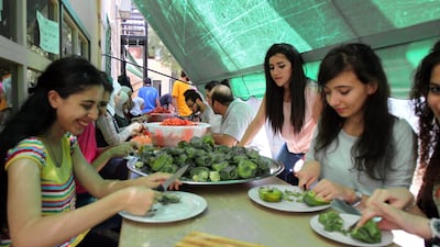 Volunteers prepare Ramadan meals for people in need in Damascus’s Al Mazzeh neighbourhood yesterday. Youssef Badawi / EPA