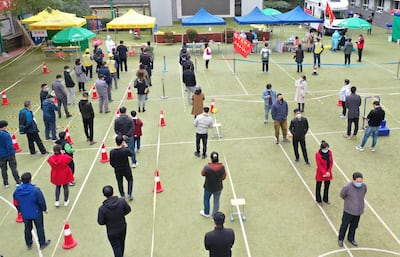 Residents wait for Covid-19 tests at a middle school in Lanzhou, in China's north-western Gansu province. AFP