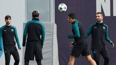 Barcelona’s Andre Gomes, Lionel Messi, Luis Suarez and Arda Turan take part in training. Lluis Gene / AFP