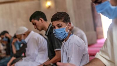 Palestinians wearing protective face masks attend Fraiday prayers as mosques reopen amid the ongoing coronavirus Covid-19 pandemic in Gaza City, Gaza Strip, 22 May 2020. EPA