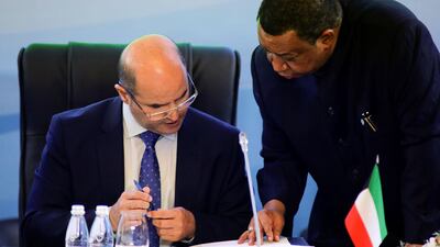 Kuwait's oil minister Essam Al Marzouq listens to Opec secretary general Mohammad Barkindo in St Petersburg, Russia. Anton Vaganov / Reuters