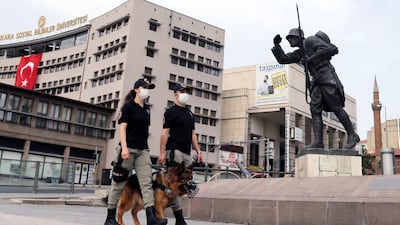 Ankara's mounted police unit officers patrol with dogs the streets in the Ulus district in Ankara, Turkey. AFP