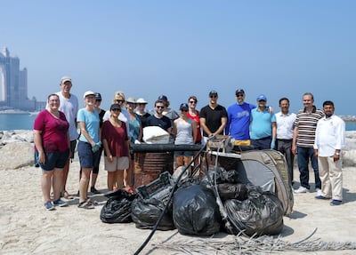 Beach clean ups can be a good way to socialise and do something worthwhile. Victor Besa / The National