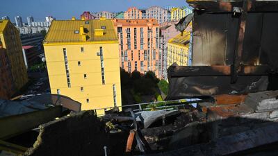 A view of Kyiv through the hole in a roof of a multi-store building damaged as a result of falling debris after a massive drone attack overnight in Kyiv. AFP