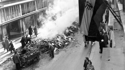 Hungarian citizens clear debris after the invasion of Soviet tanks in 1956, following a spontaneous nationwide anti-Stalinist revolt.