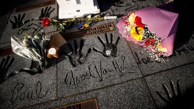 Flowers, candles and guitar picks sit next to Eddie Van Halen's hand prints on Hollywood's Rock Walk in Hollywood, California. EPA