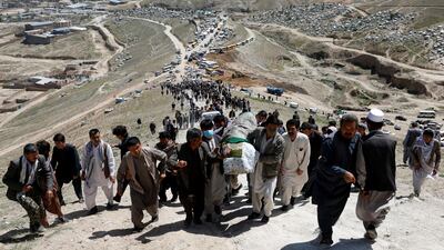 Men carry the coffin of a victim of Saturday's bombing outside a school, during a mass funeral ceremony in Kabul, Afghanistan. Reuters
