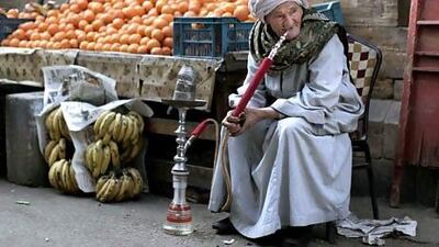 An Egyptian fruit vendor waits for customers in Cairo. Muhammed Muheisen / AP Photo
