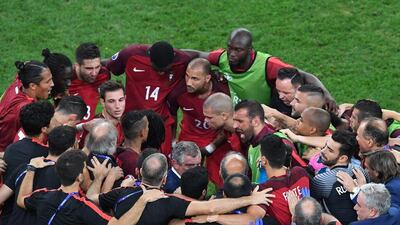 Portugal players and staff in a huddle ahead of extra time. Boris Horvat / AFP