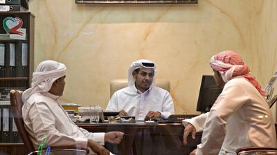 Ajman, August 7, 2011 - Owner of Al Marabieal Arabia Real Estate Ahmed Salem Ahmed (C) talks with agents Essa Mohammad (L) and Mahmoud Hassan (R) in the company's office in Ajman City, August 7, 2011. Salem has lived all of his 31 years in Ajman City. "We feel at home here," Ahmed says of Ajman City. "Ajman is the sea and I am the fish. If the fish leave the sea they die. If I leave Ajman I feel bad," Ahmed says. (Jeff Topping/The National)