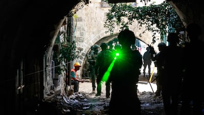 Israeli soldiers pass through a market in the Old City of Nablus, in the occupied West Bank. AFP