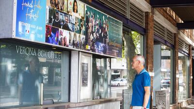 A man is seen reading a temporary closure sign on the box office window of the Palace Verona Cinema, Paddington in Sydney. Getty Images