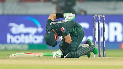 Mohammad Rizwan holds his back after getting a cramp in Hyderabad. AP