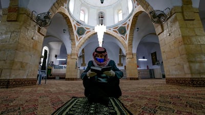 A Palestinian man reads the Koran alone at the al-Qazazin mosque in the occupied West Bank town of Hebron. AFP