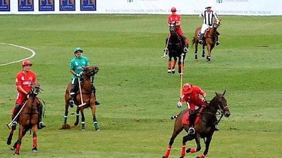 Team London, red, takes on Team Moscow, green, at Hurlingham Park in London, where polo's new format was first tried out in 2009. Zak Hussein / PA Archive