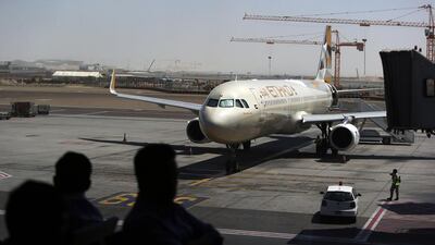Etihad Airways passengers wait to board a flight at Abu Dhabi International Airport. Delores Johnson / The National
