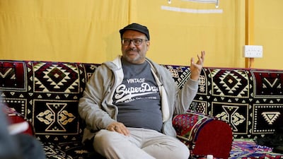 A Kuwaiti man gestures while sitting inside a tent at the camp on January 13, 2017. Yasser Al Zayyat / AFP