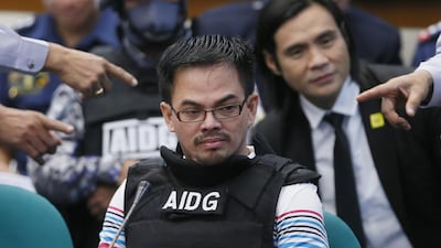 Wearing a bulletproof vest, Rolando ‘Kerwin’ Espinosa Jr prepares to testify on his involvement in the illegal drug trade. Mr Espinosa was extradited from Abu Dhabi last Friday. Bullit Marquez / AP Photo