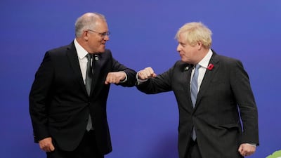 Britain's Prime Minister Boris Johnson greets Australia's Prime Minister Scott Morrison as they arrive to attend the Cop26 UN Climate Change Conference in Glasgow, Scotland, on November 1, 2021. AFP