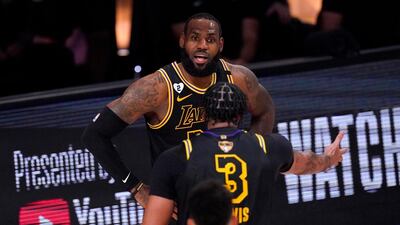 Los Angeles Lakers' Anthony Davis (3) and LeBron James talk on the court. AP