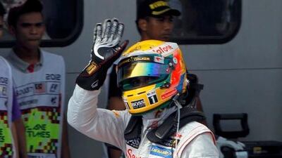Lewis Hamilton waves to the crowd after clinching pole position.