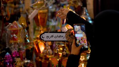 A Saudi woman takes a picture of decorations in the Saudi coastal city of Jeddah ahead of Ramadan. AFP