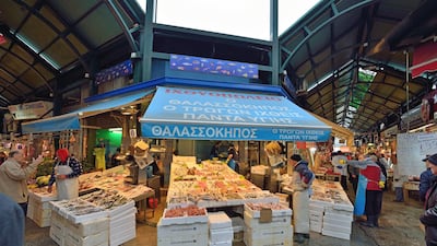 A fish merchant chats with a customer at the open-air Kapani market. Courtesy Carlo Raciti