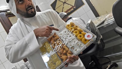 Muhana Fouad Hussain Showaiter, general manager at Hussain Showaiter Sweets and fifth generation member of the family-run business, shows special packaging introduced for Ramadan during a factory tour on Muharraq island.