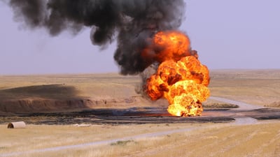 A picture taken on August 10, 2016 shows flames and smoke rising from a well on fire at Bai Hassan oil field, the largest in Iraqi oil-rich Kirkuk province. AFP